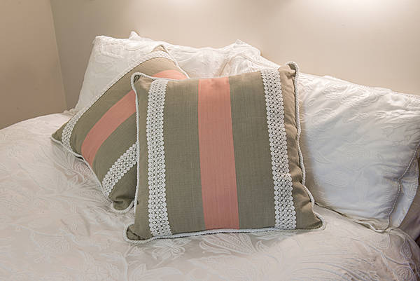 white bed with green pillows