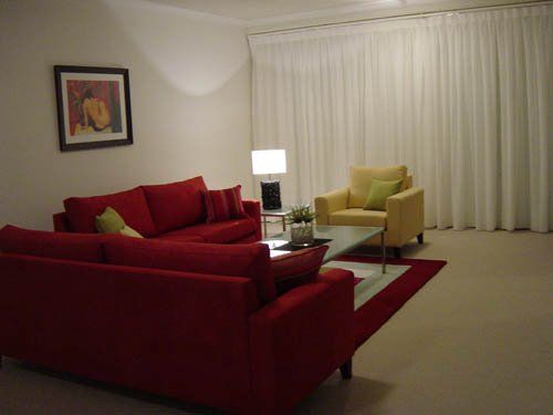 room with red sofas