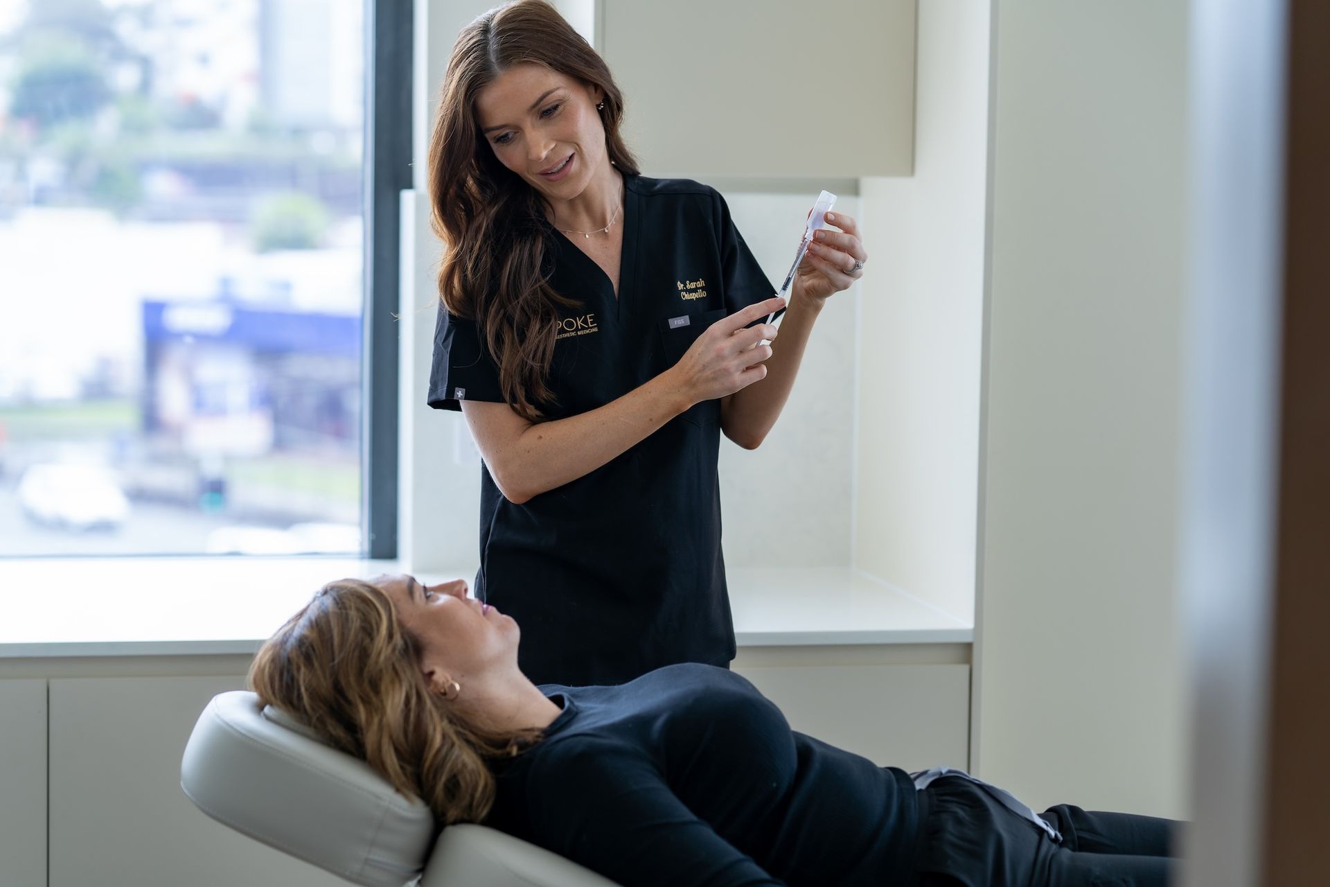 A Woman is Getting a IV Injection — Bespoke Longevity and Aesthetic Medicine In Southport, QLD