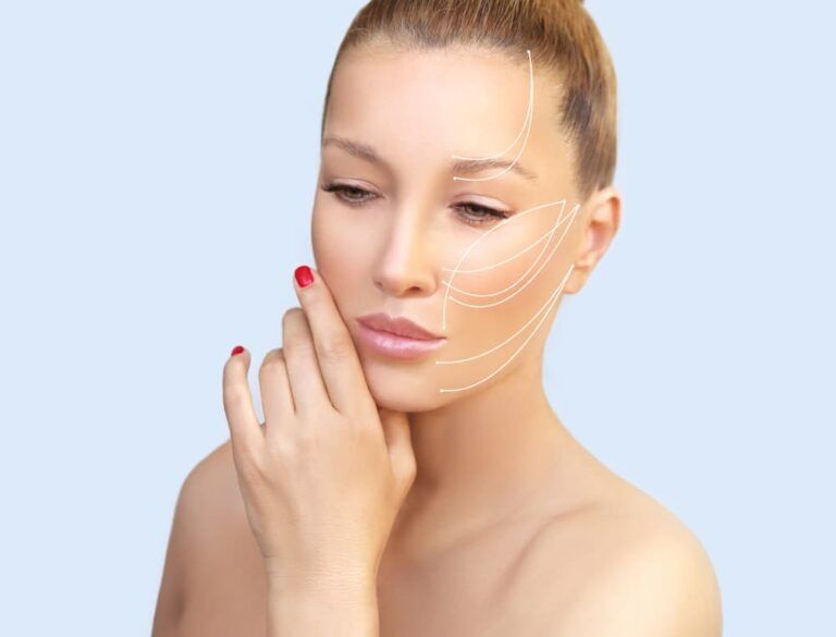 A Woman is Touching Her Face and Has Lines Drawn on Her Face — Bespoke Longevity and Aesthetic Medicine In Southport, QLD