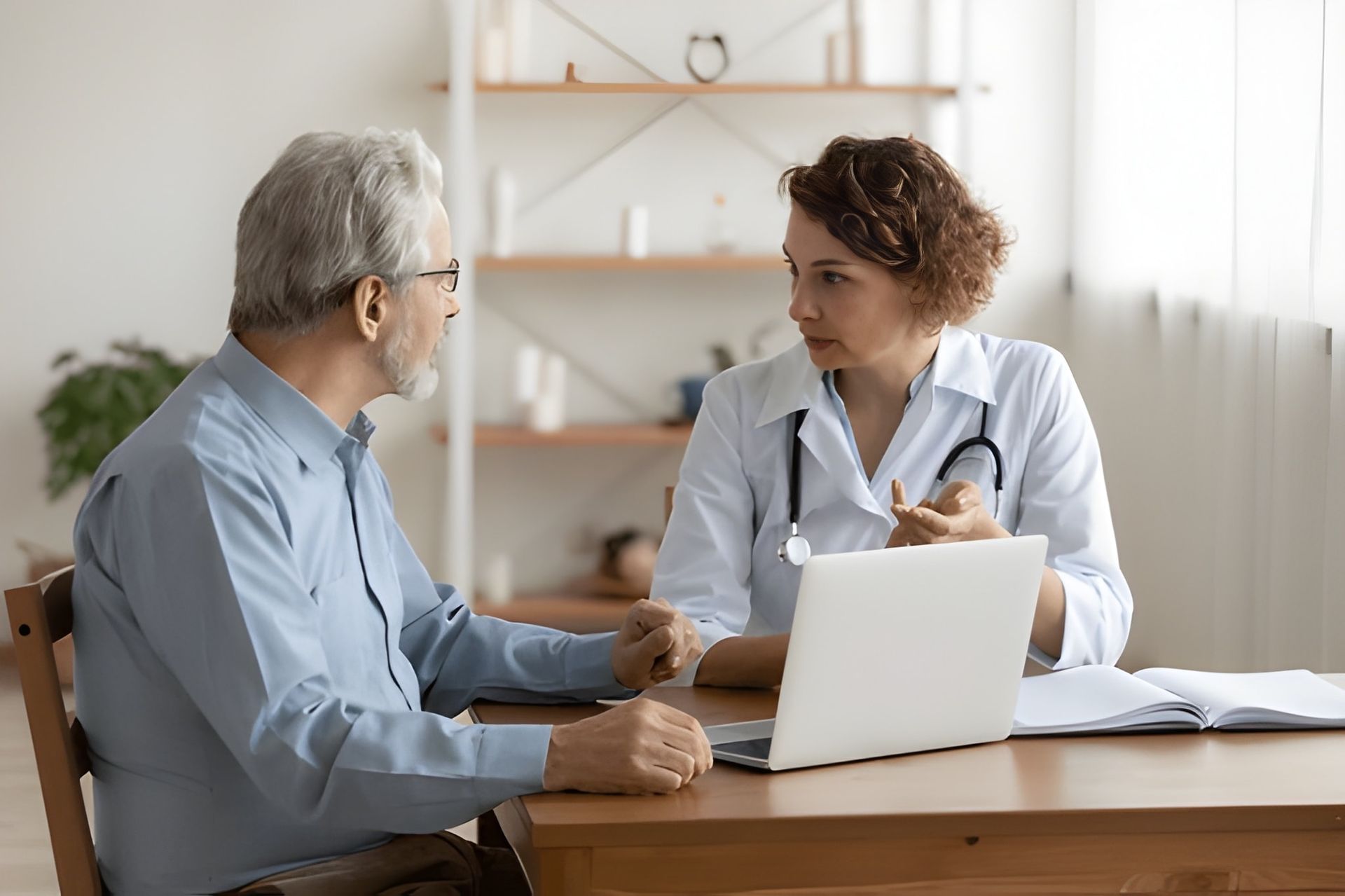 A Doctor in a White Coat Consults With an Older Patient — Bespoke Longevity and Aesthetic Medicine In Southport, QLD