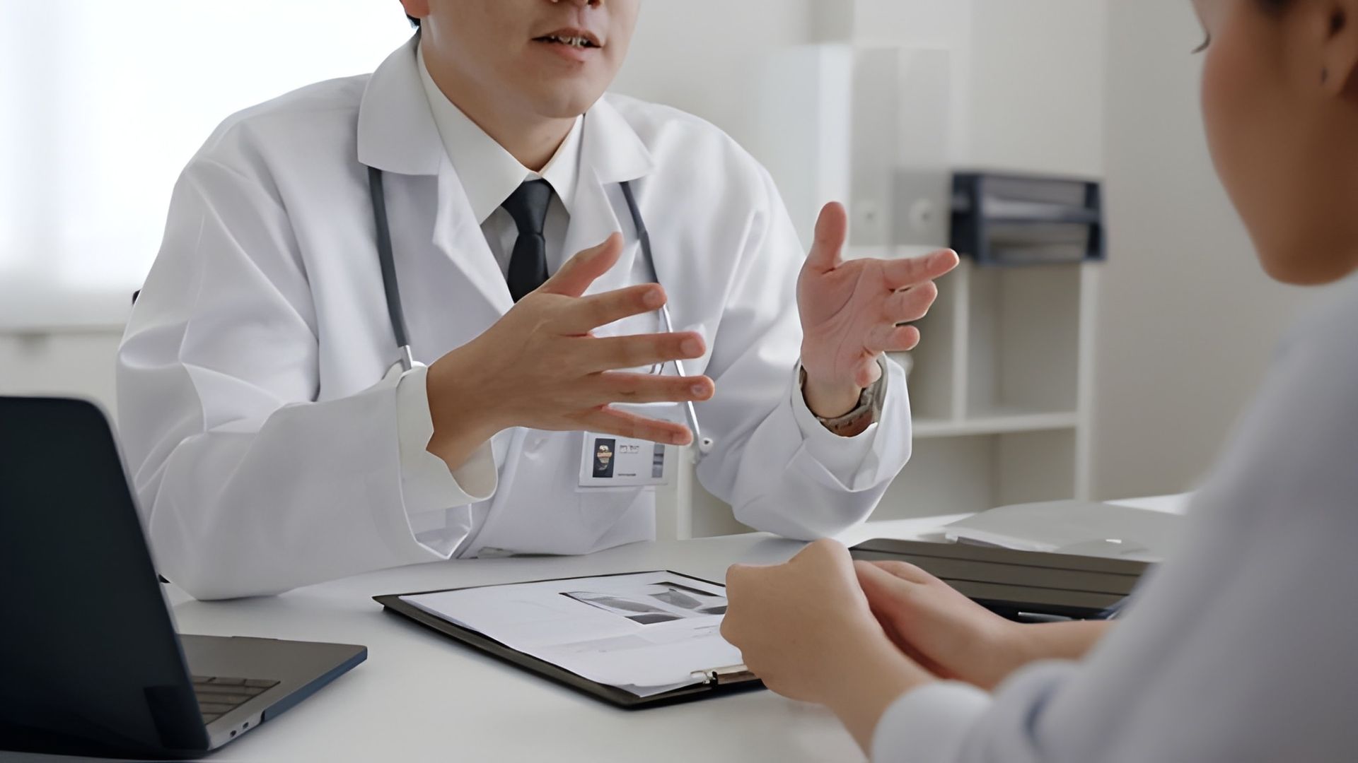 Doctor Talking to a Patient in a Medical Office — Bespoke Longevity and Aesthetic Medicine In Southport, QLD