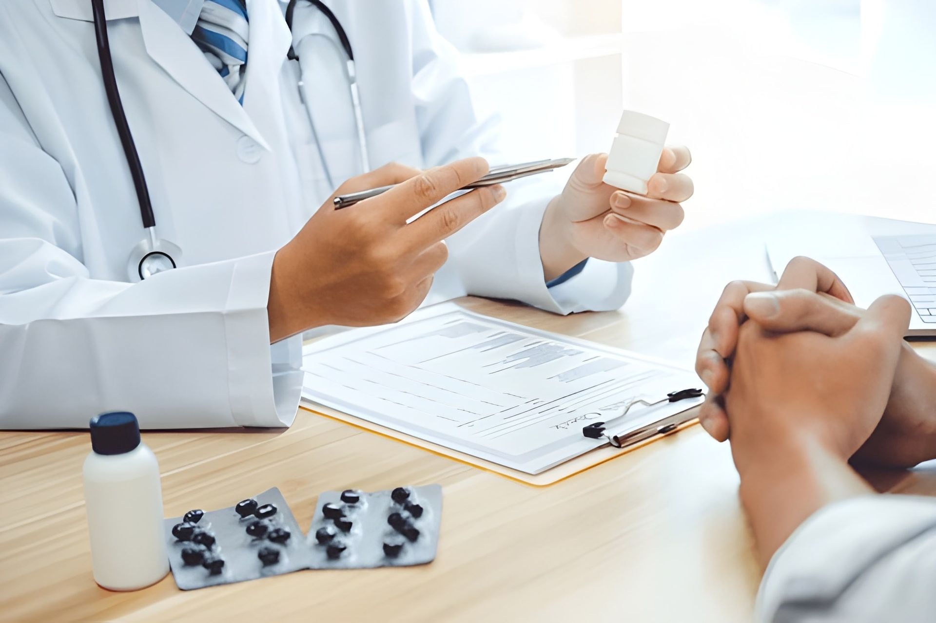 Doctor Explaining Medication to a Patient at a Desk — Bespoke Longevity and Aesthetic Medicine In Southport, QLD