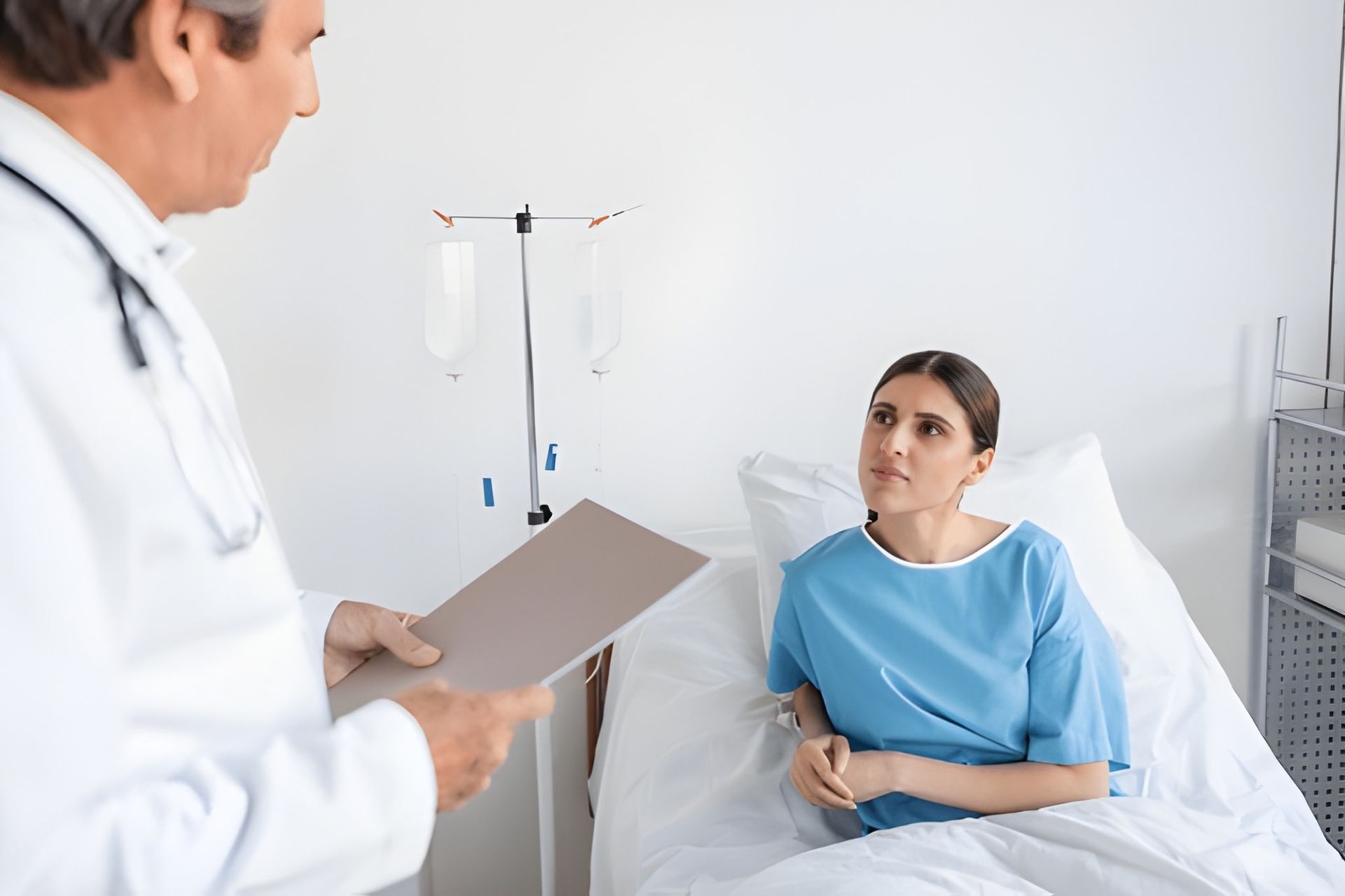 Doctor Talking to a Woman Patient in a Hospital Bed — Bespoke Longevity and Aesthetic Medicine In Southport, QLD