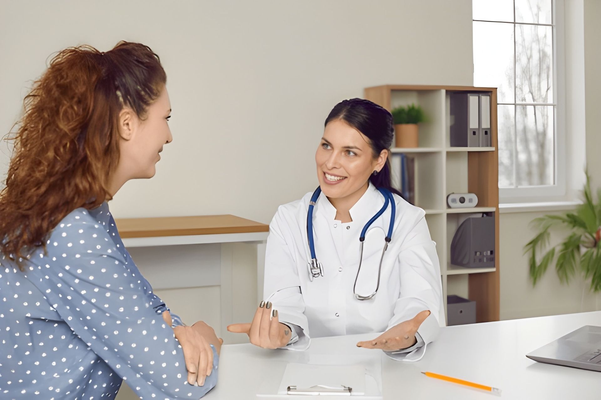 Doctor in White Coat With Stethoscope Consults With Patient — Bespoke Longevity and Aesthetic Medicine In Southport, QLD