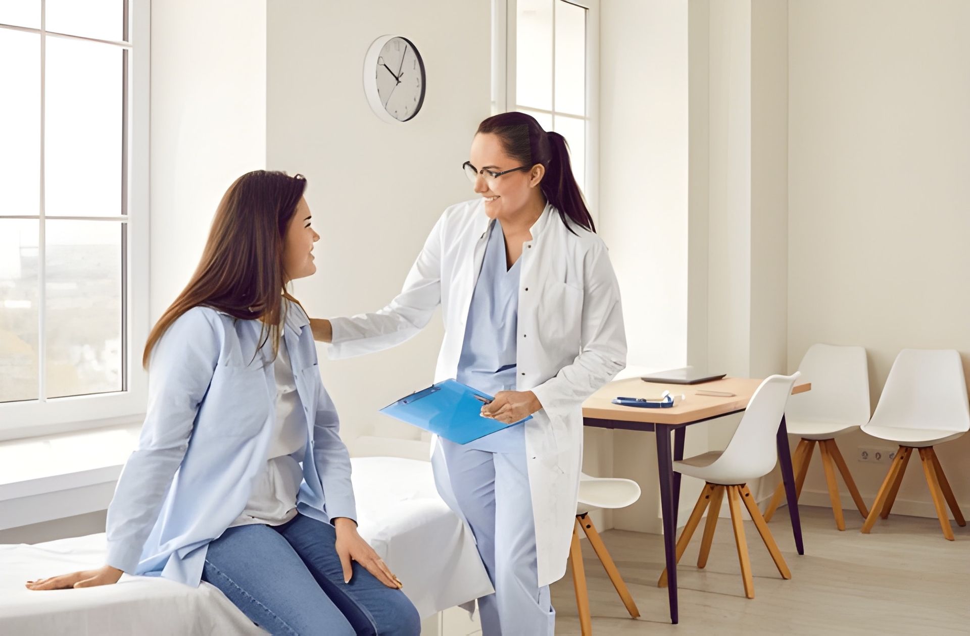 Doctor Wears a Lab Coat While Patient is Seated on a Bed — Bespoke Longevity and Aesthetic Medicine In Southport, QLD