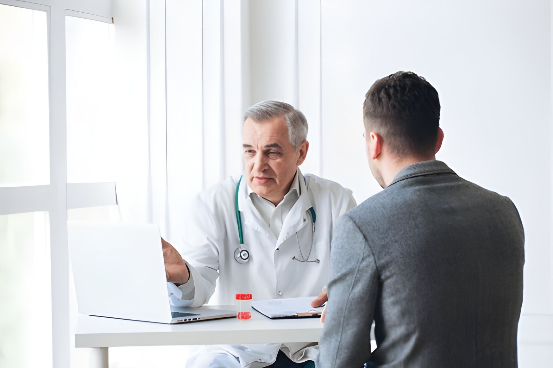 Doctor in White Consulting With a Patient — Bespoke Longevity and Aesthetic Medicine In Southport, QLD