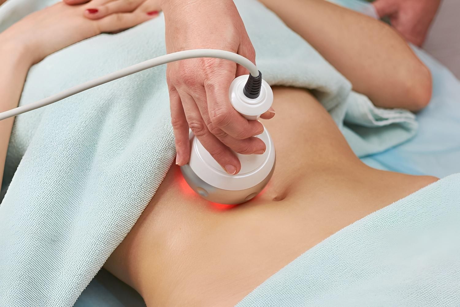Person Receiving Body Contouring Treatment on Their Abdomen — Bespoke Institute In Southport, QLD