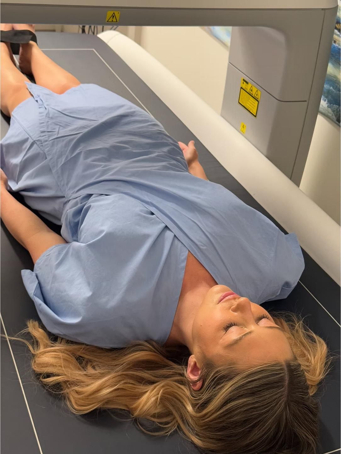 A Woman in A Blue Gown Is Laying on A Table — Bespoke Institute In Southport, QLD