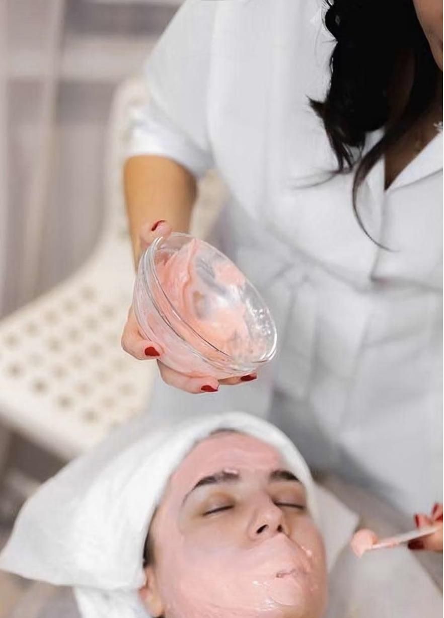 A Woman Is Getting a Facial Treatment at A Spa — Bespoke Institute In Southport, QLD