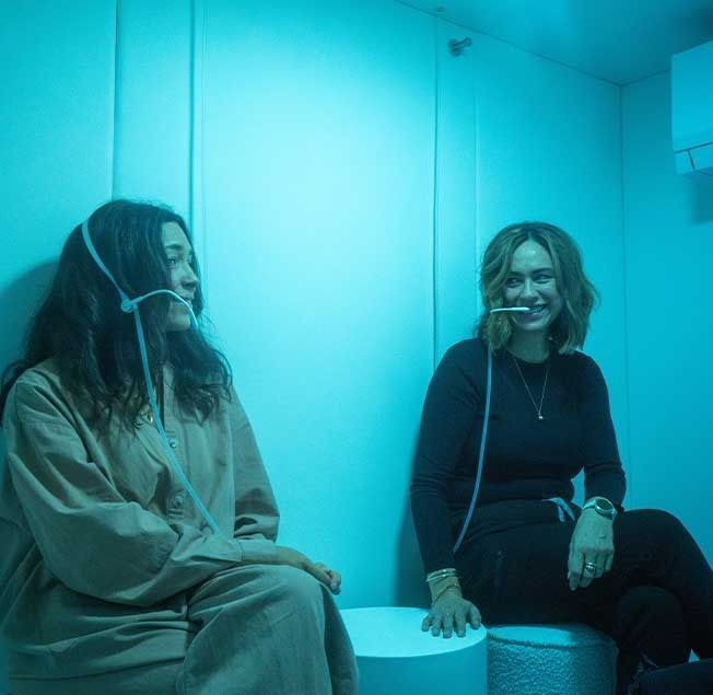 Two Women Sitting Next to Each Other in a Room — Bespoke Longevity and Aesthetic Medicine In Southport, QLD