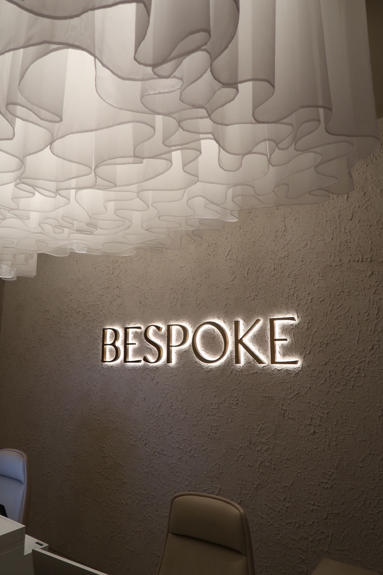 A Reception Area With a Sign That Says Bespoke on the Wall — Bespoke Longevity and Aesthetic Medicine In Southport, QLD