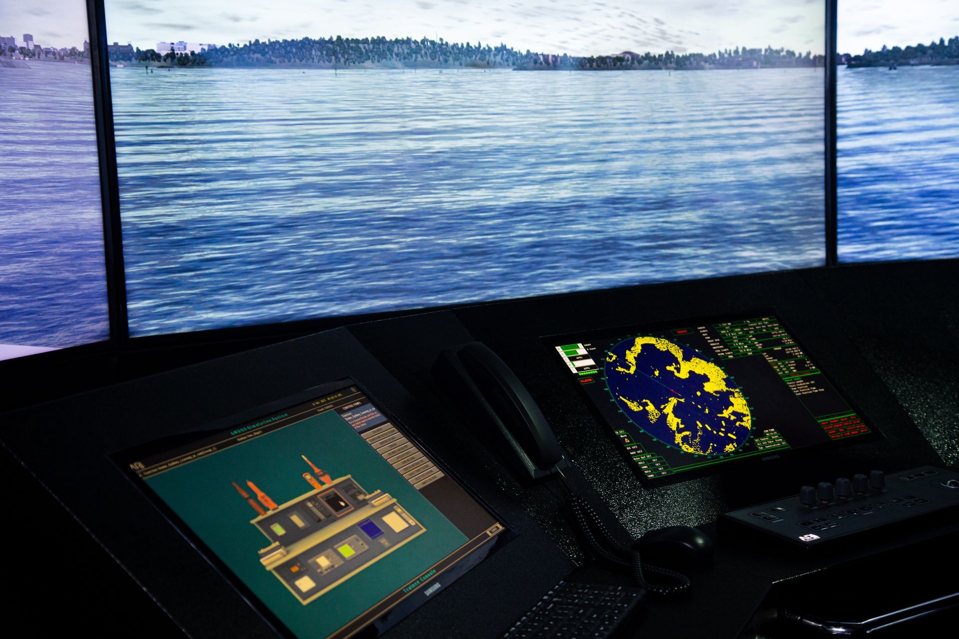 Boat bridge with three navigation displays showing radar and charts overlooking open water