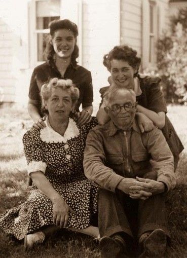 A black and white photo of a family posing for a picture.