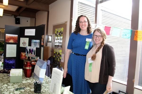 Two women standing next to each other in a room