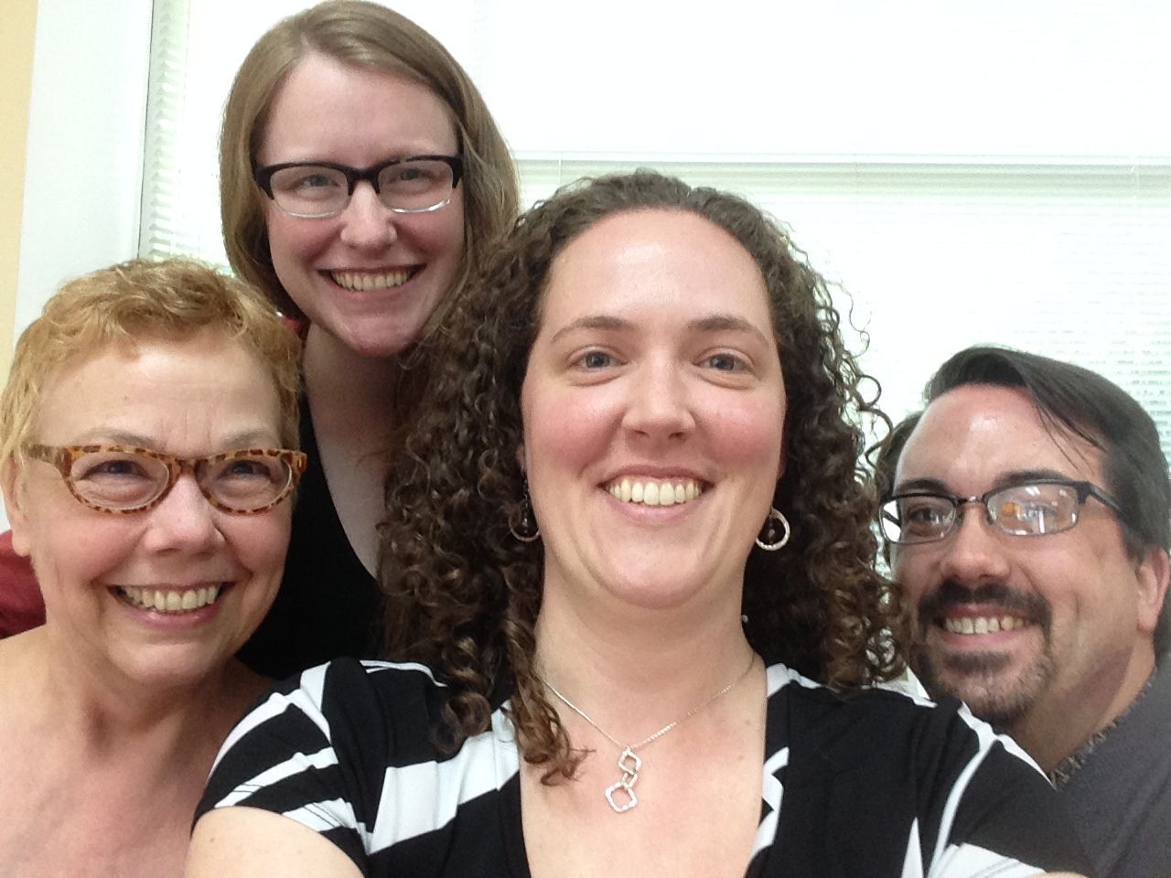 A group of people are posing for a picture and smiling for the camera