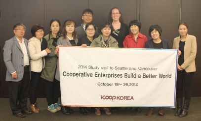 A group of people holding a banner that says cooperative enterprises build a better world.