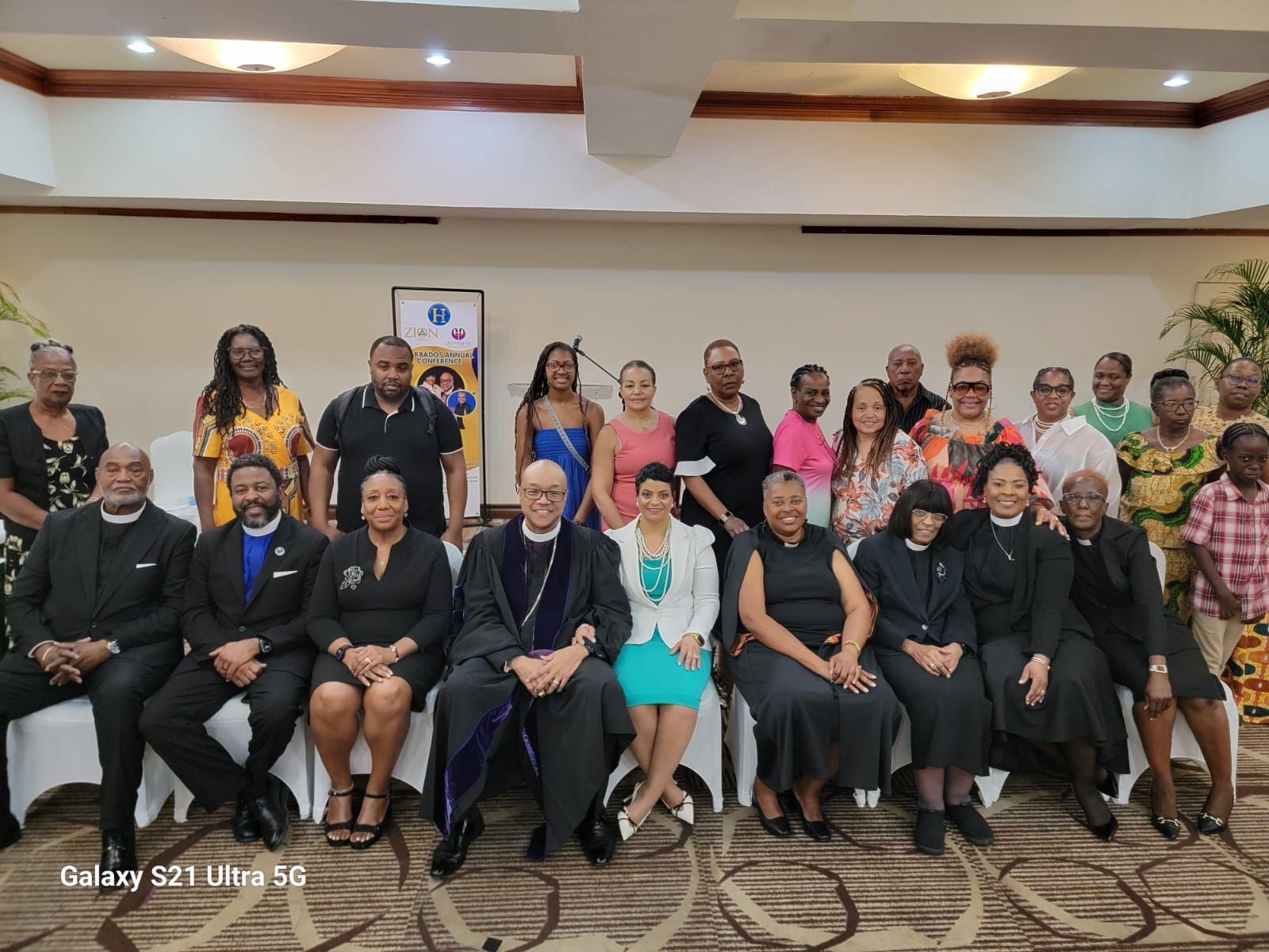 A group of people are posing for a picture in a room.
