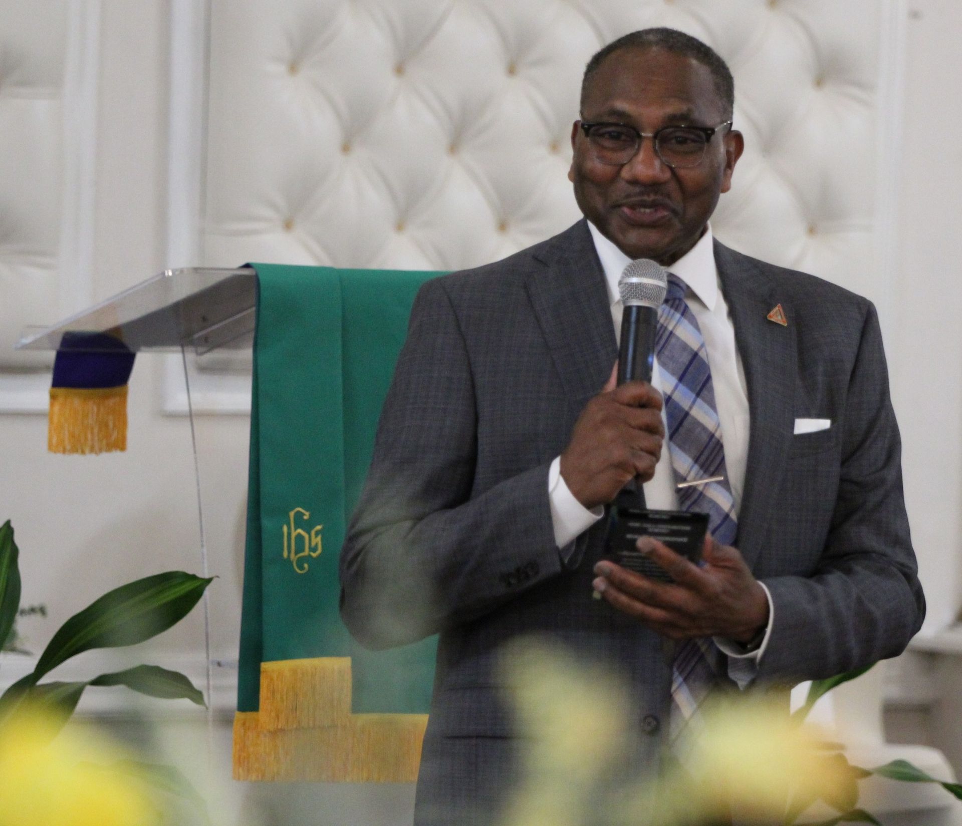 A man in a suit and tie is holding a microphone