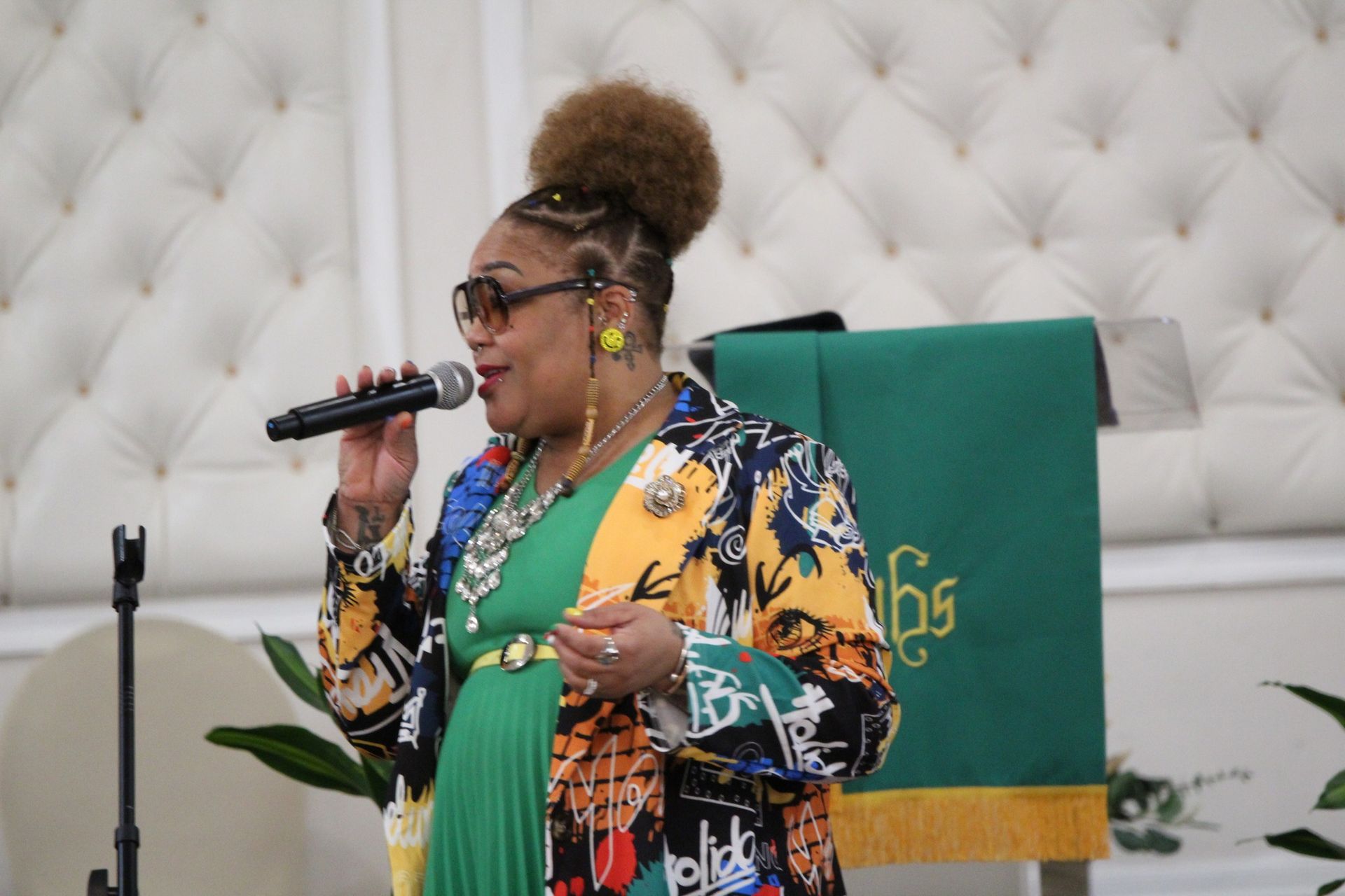 A woman is singing into a microphone in a church.