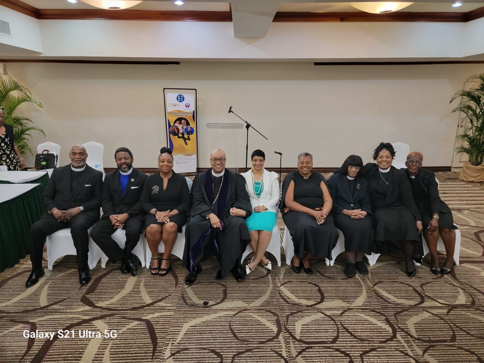 A group of people are posing for a picture in a room.