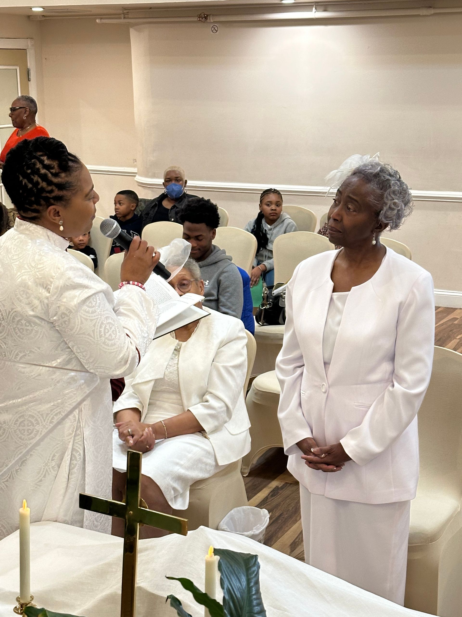 A woman is giving a sermon to a group of people in a church.
