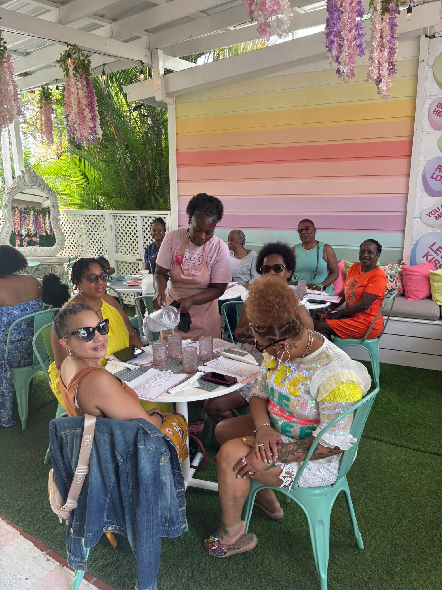 A group of women are sitting at tables in a restaurant.