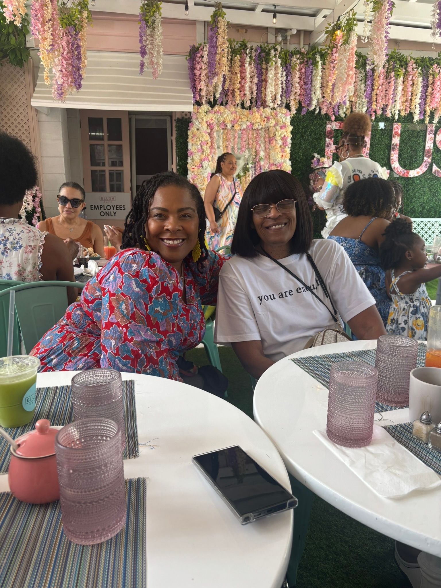 Two women are sitting at a table in a restaurant.