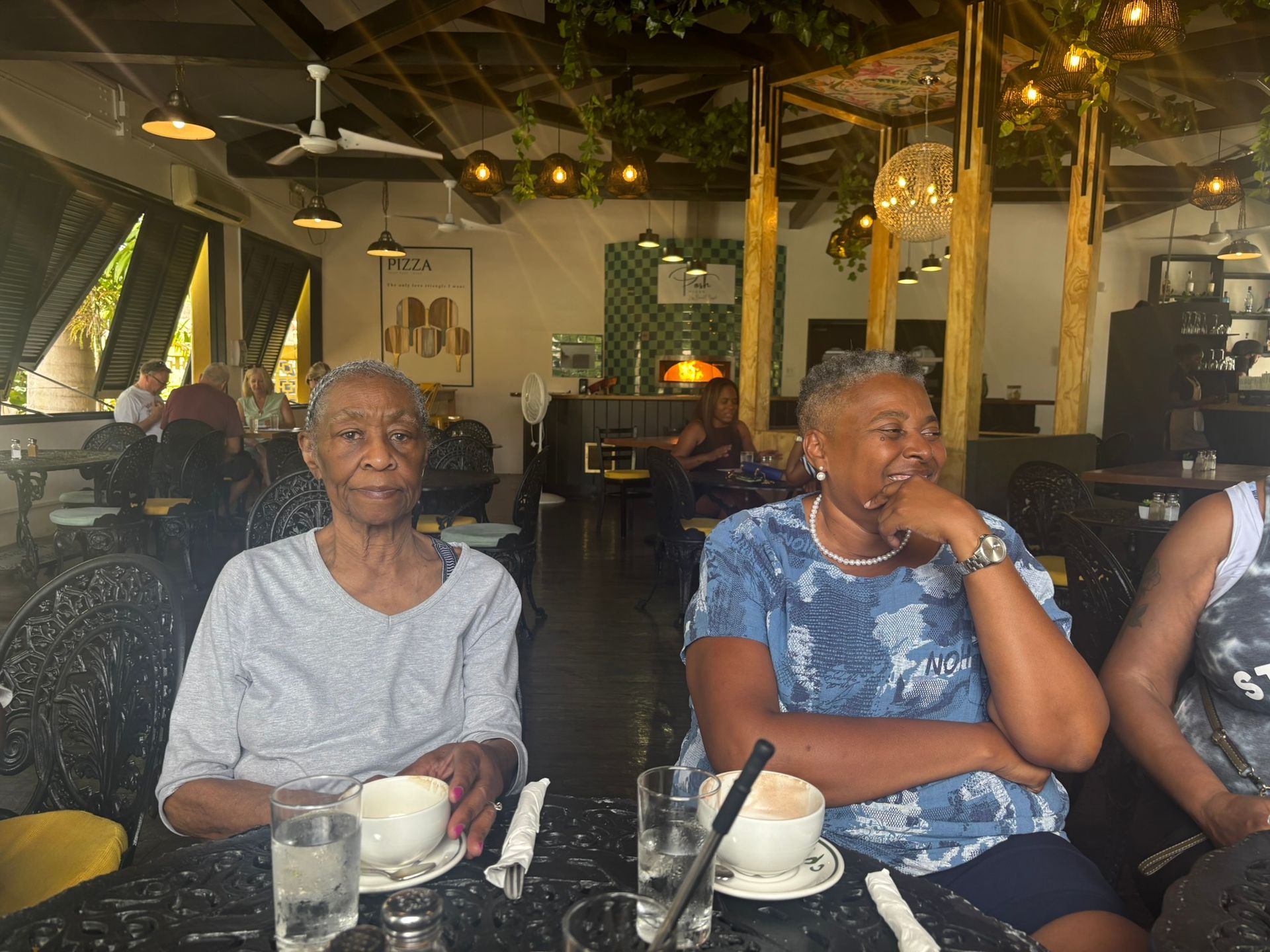 Three older women are sitting at a table in a restaurant.