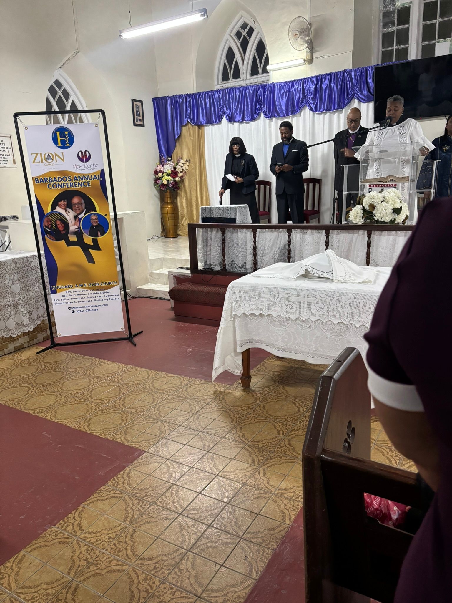 A man is standing at a podium in a church giving a speech.