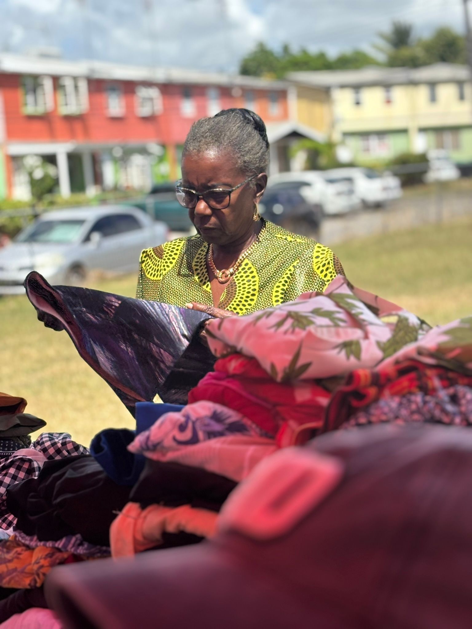 A woman is standing in front of a pile of clothes.