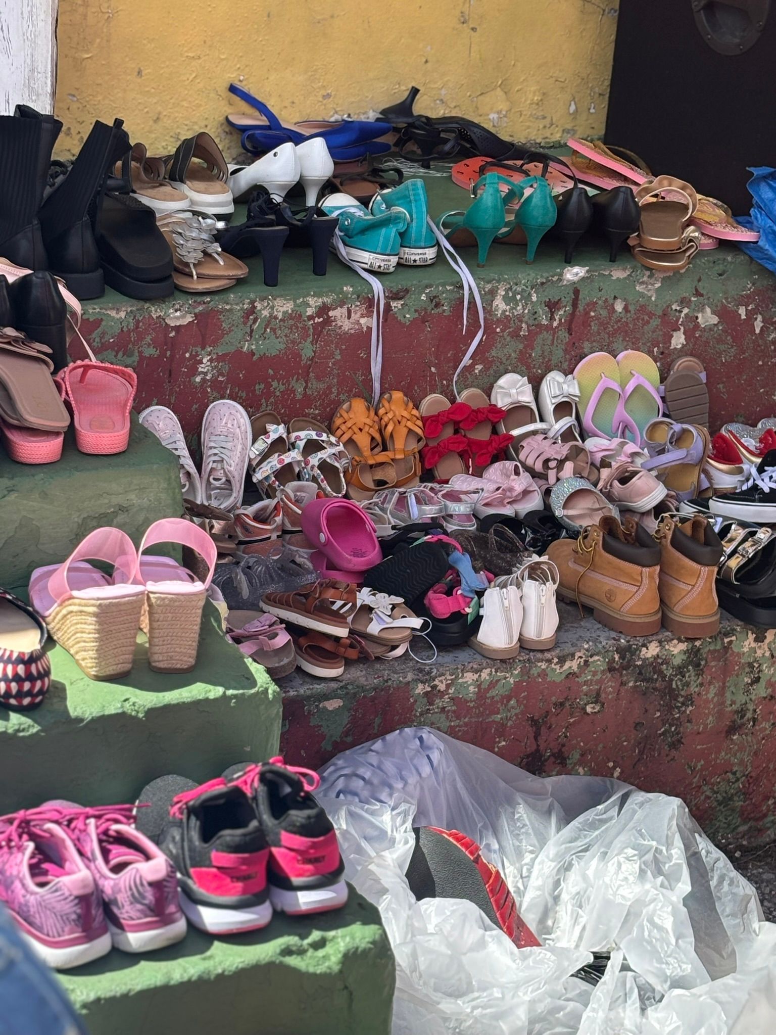 A bunch of shoes are sitting on top of a table.
