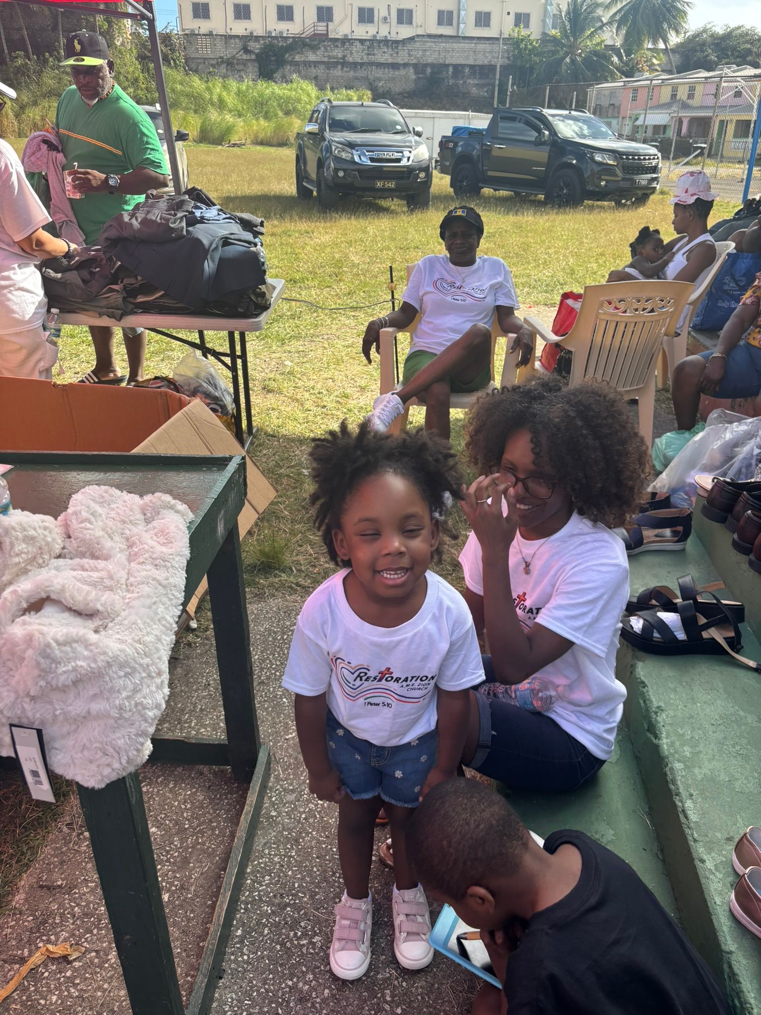 A group of people are sitting on steps in a park.