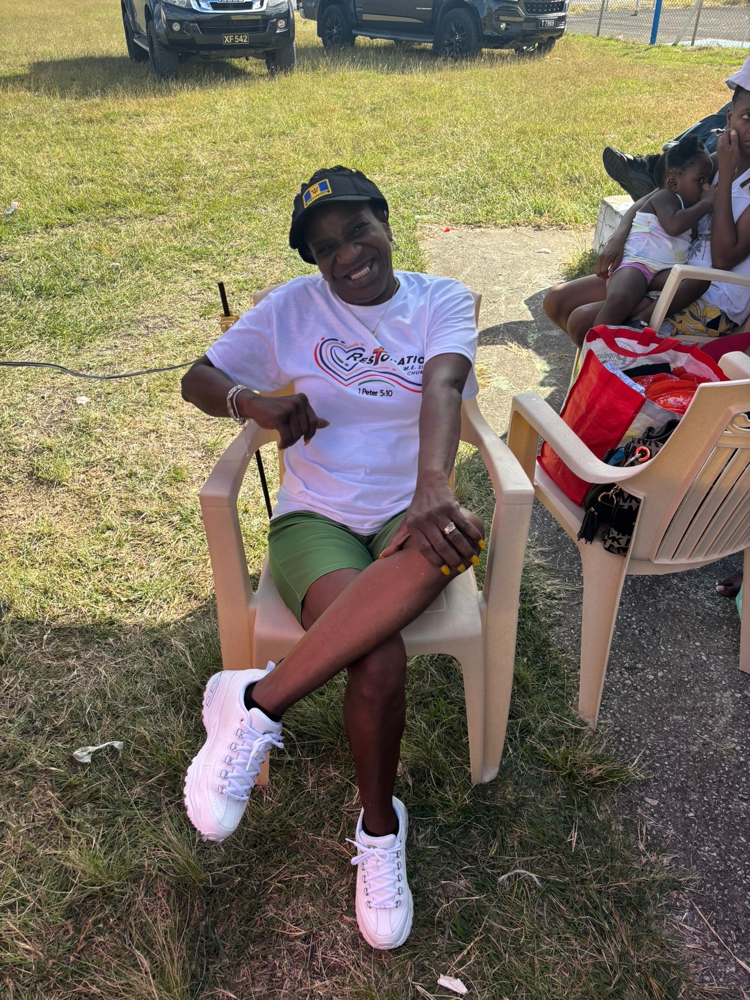 A woman is sitting in a chair with her legs crossed.