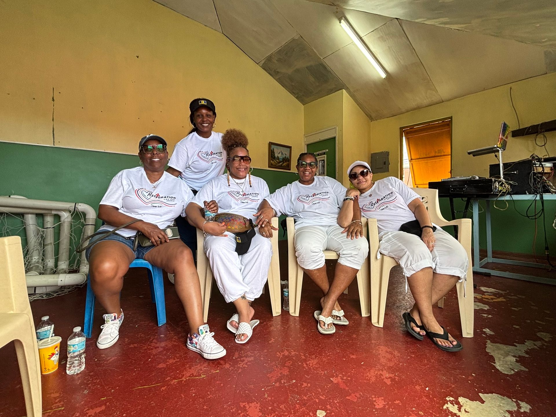 A group of women are sitting in chairs in a room.