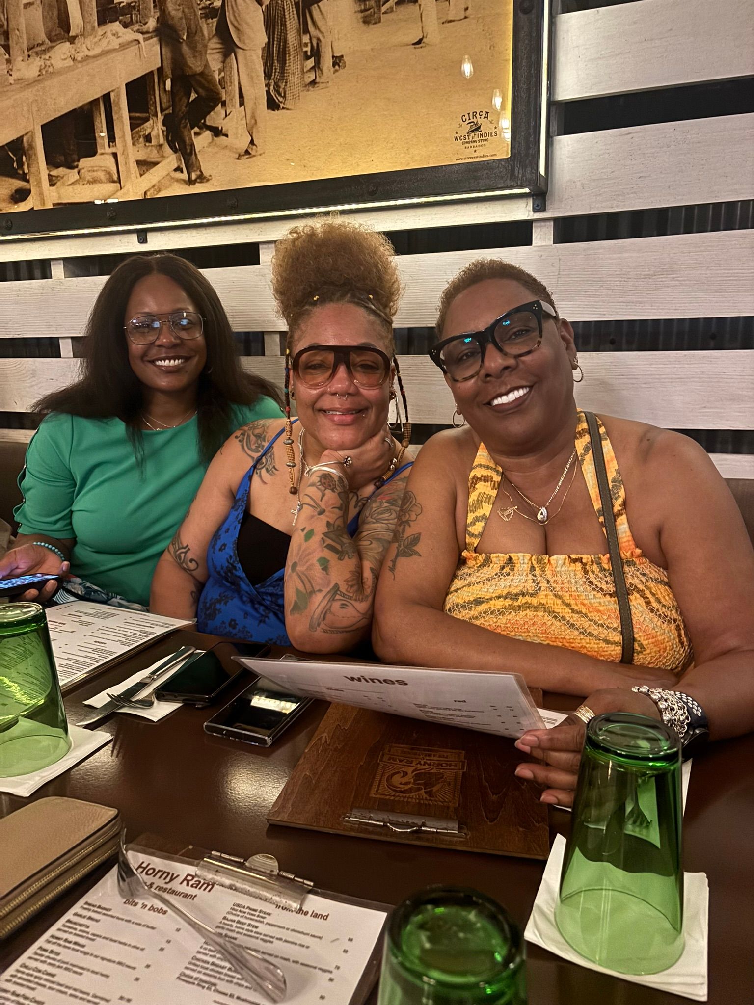 Three women are sitting at a table in a restaurant.