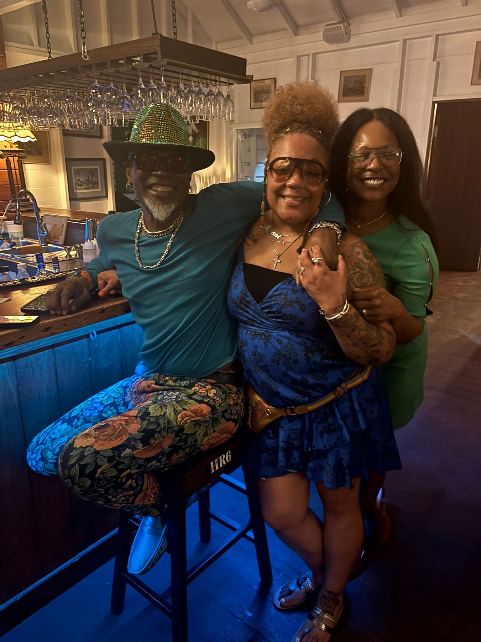 A man and two women are posing for a picture in a restaurant.
