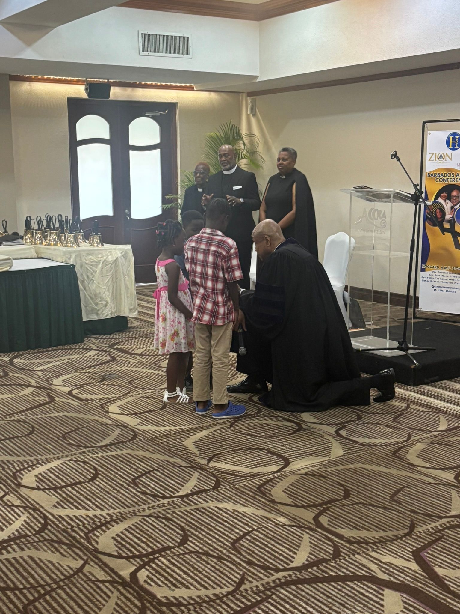 A group of people are standing in a room with a sign that says corona on it.