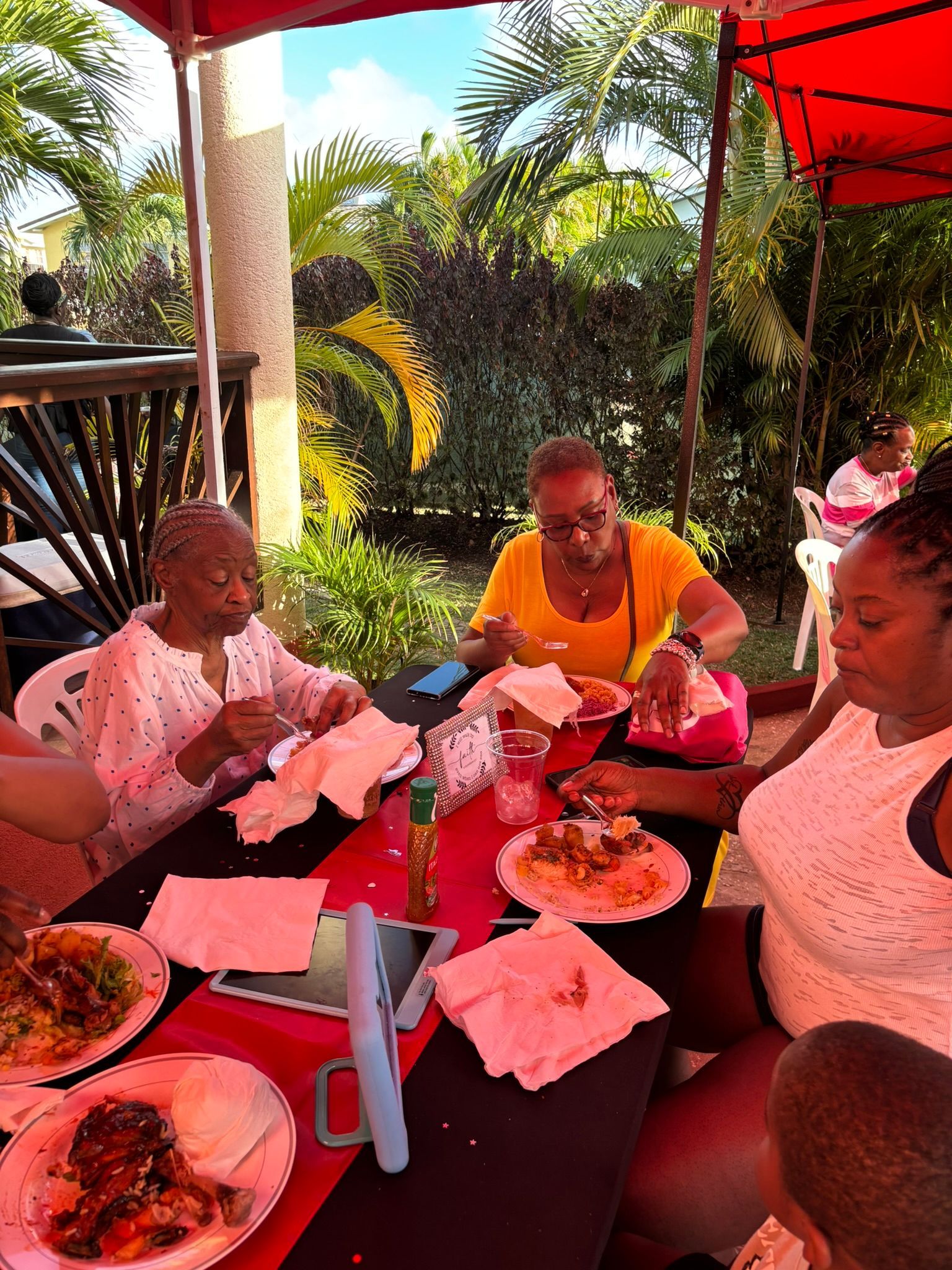 A group of people are sitting at a table eating food.