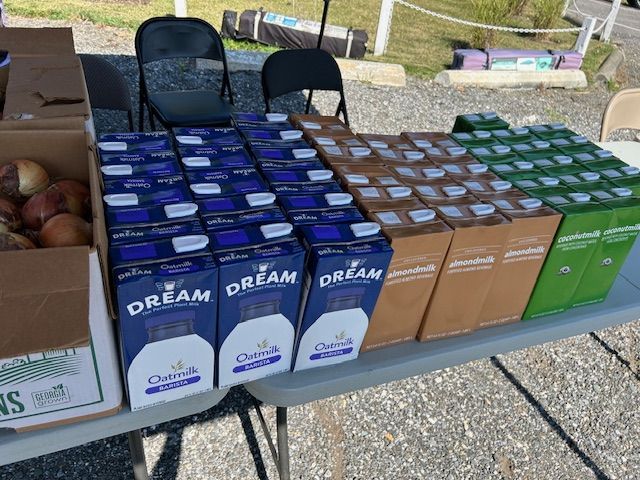 A table full of boxes of dream apple juice