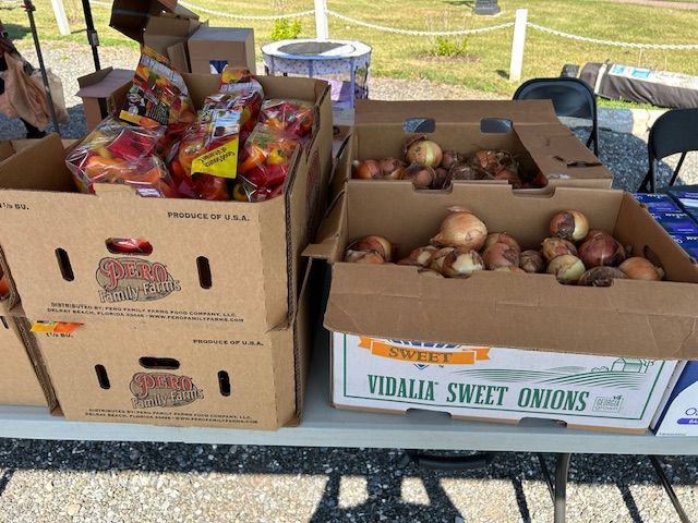 Boxes of vidalia sweet onions are stacked on top of each other on a table.