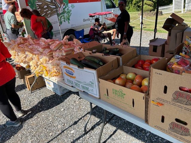 A table with boxes of fruit and vegetables on it