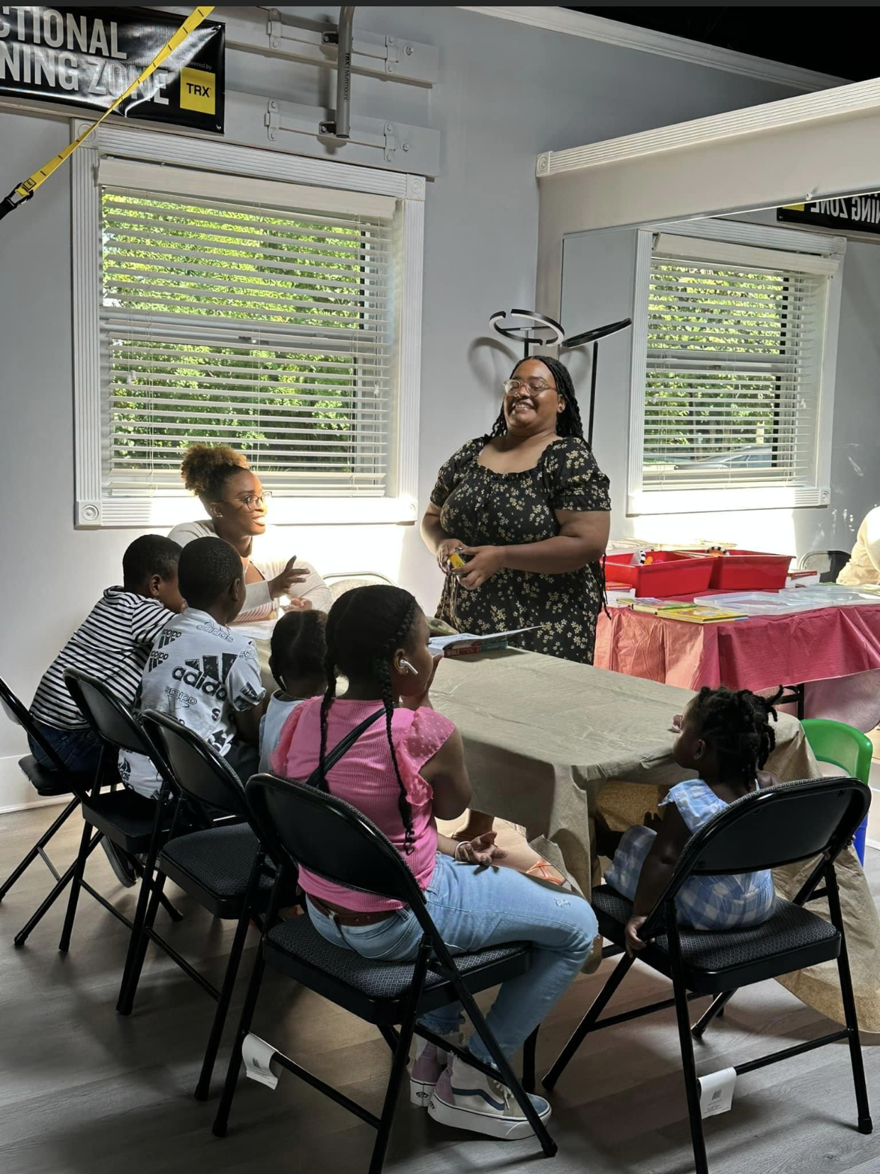 A group of people are sitting around a table in a room.