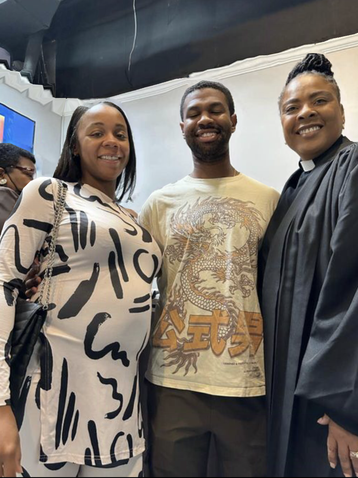 A man and two women are posing for a picture together.