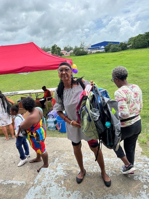 A woman is carrying a large backpack on her back