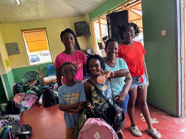 A group of young women are posing for a picture in a room.