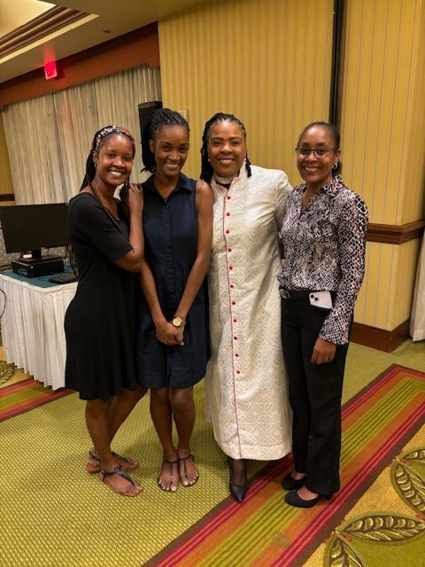 A group of women are posing for a picture in a room.