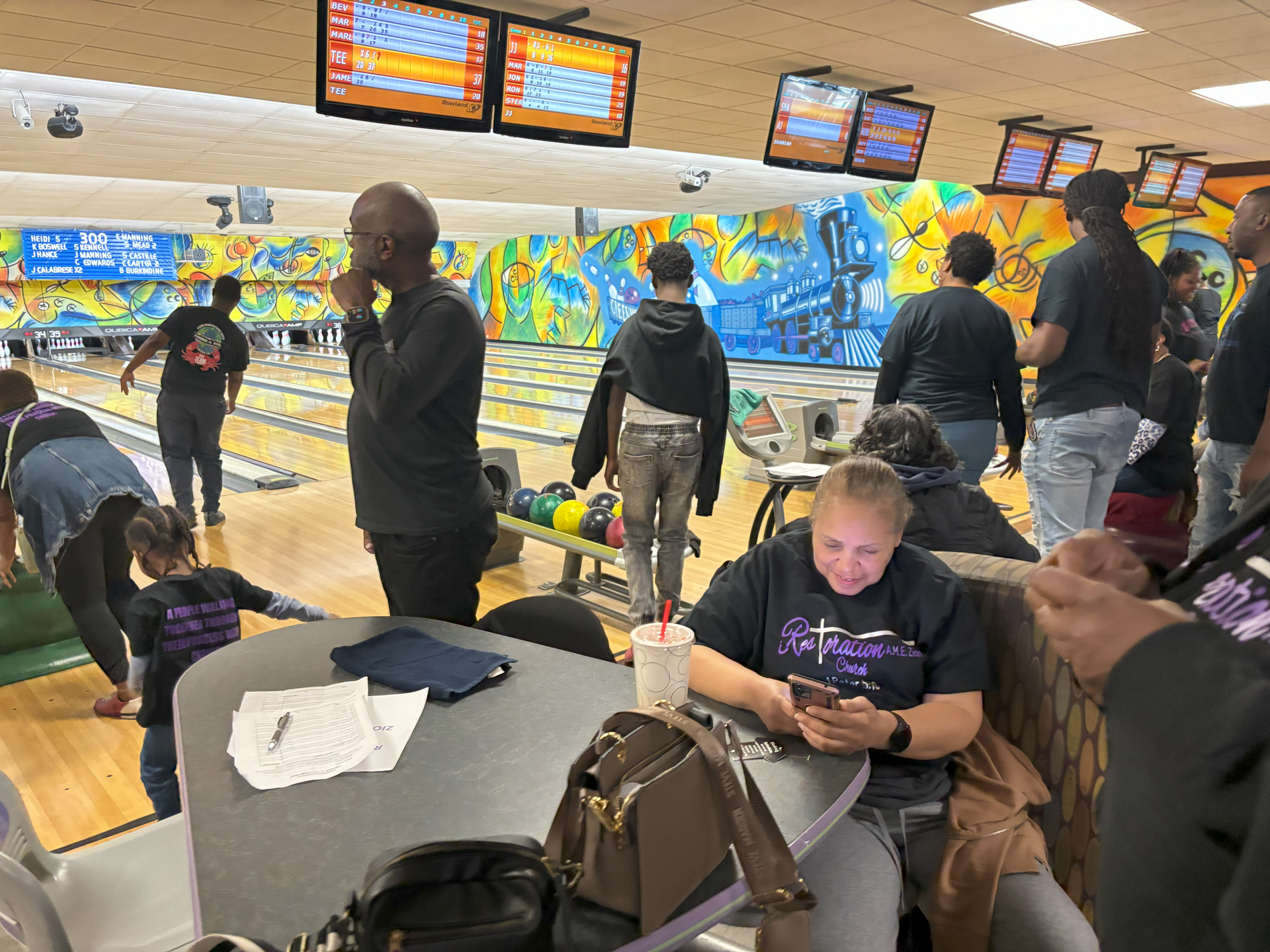A group of people are playing bowling in a bowling alley.