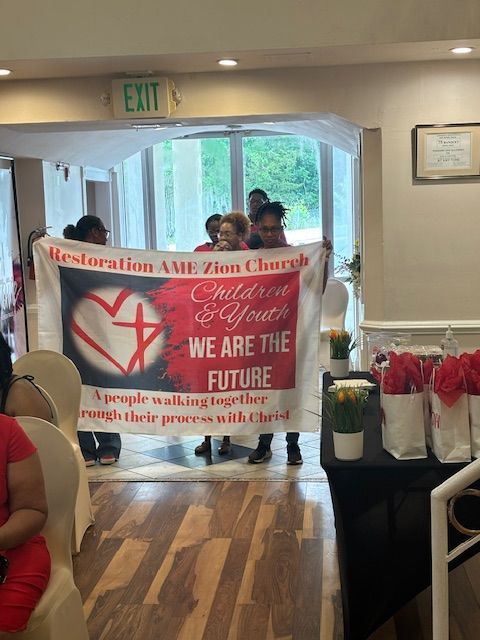 A group of people holding a sign that says we are the future