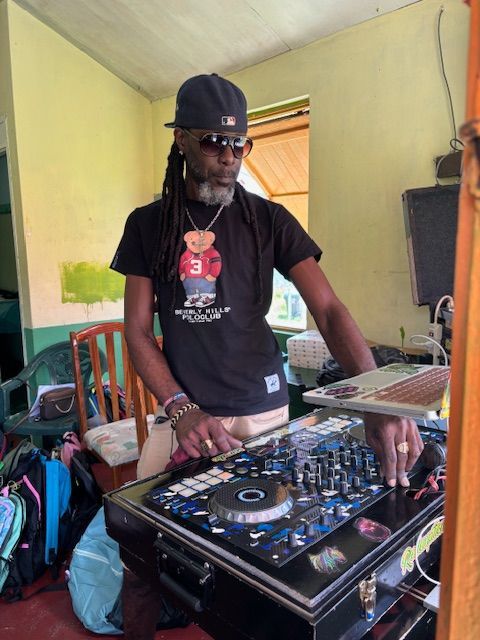 A man wearing a polo bear shirt is playing music